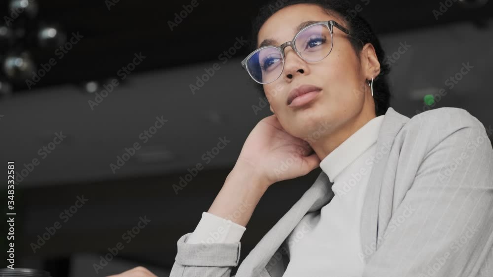 Amazing serious african young business woman indoors in office Amazing serious african young business woman indoors in office
