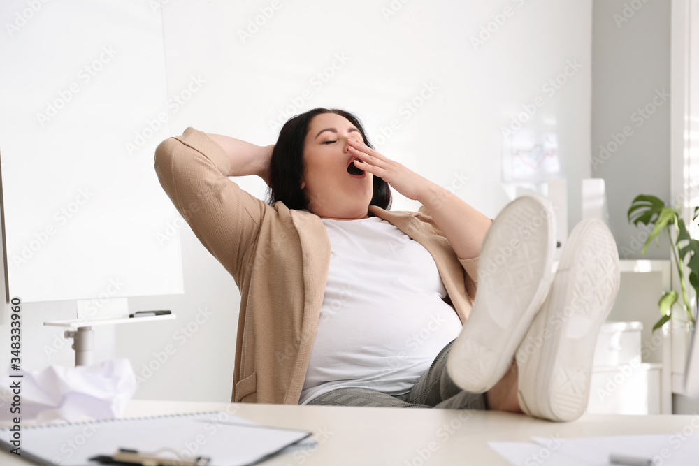 Lazy overweight worker with feet on desk in office Lazy overweight worker with feet on desk in office