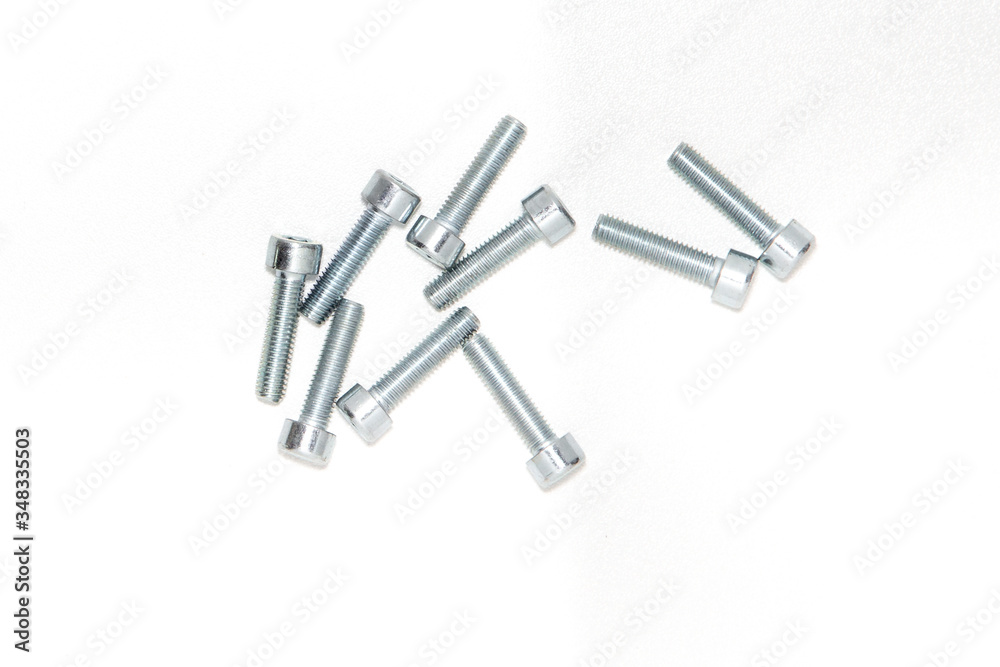 Top view of hexagon socket Bolts. Pile of stainless steel bolts on bright white background with silver color with copy space. 3d illustration Top view of hexagon socket Bolts. Pile of stainless steel bolts on bright white background with silver color with copy space. 3d illustration