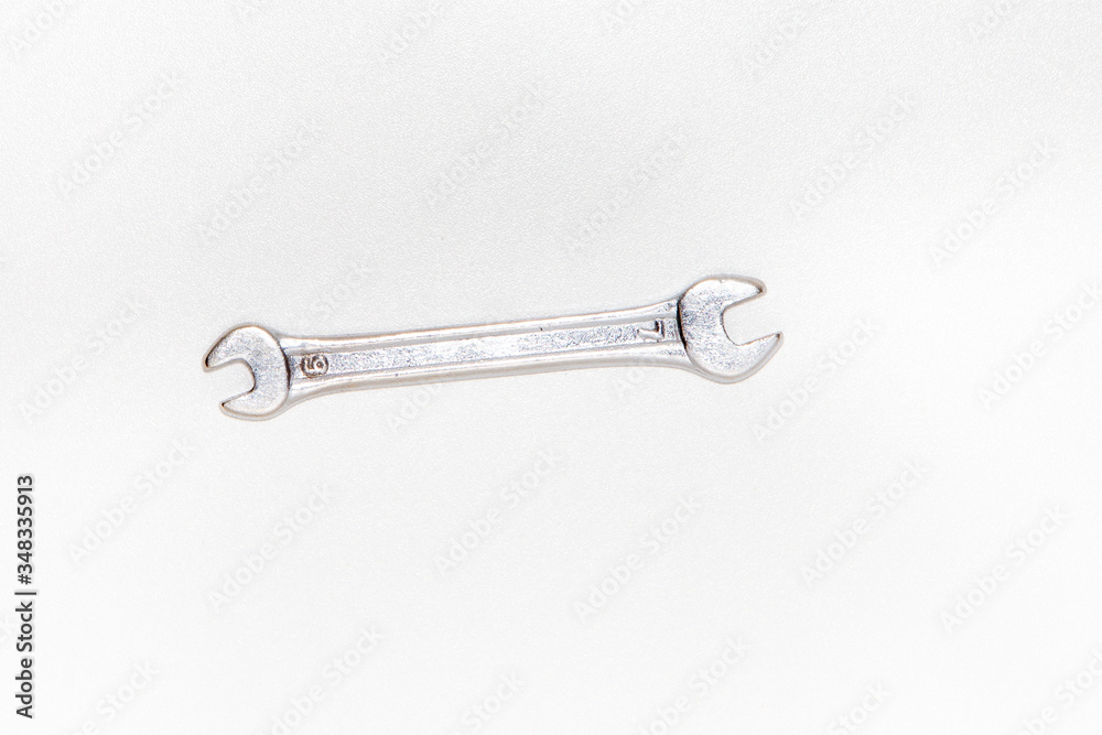 Wrench isolated on bright white background with silver color, top view Wrench isolated on bright white background with silver color, top view