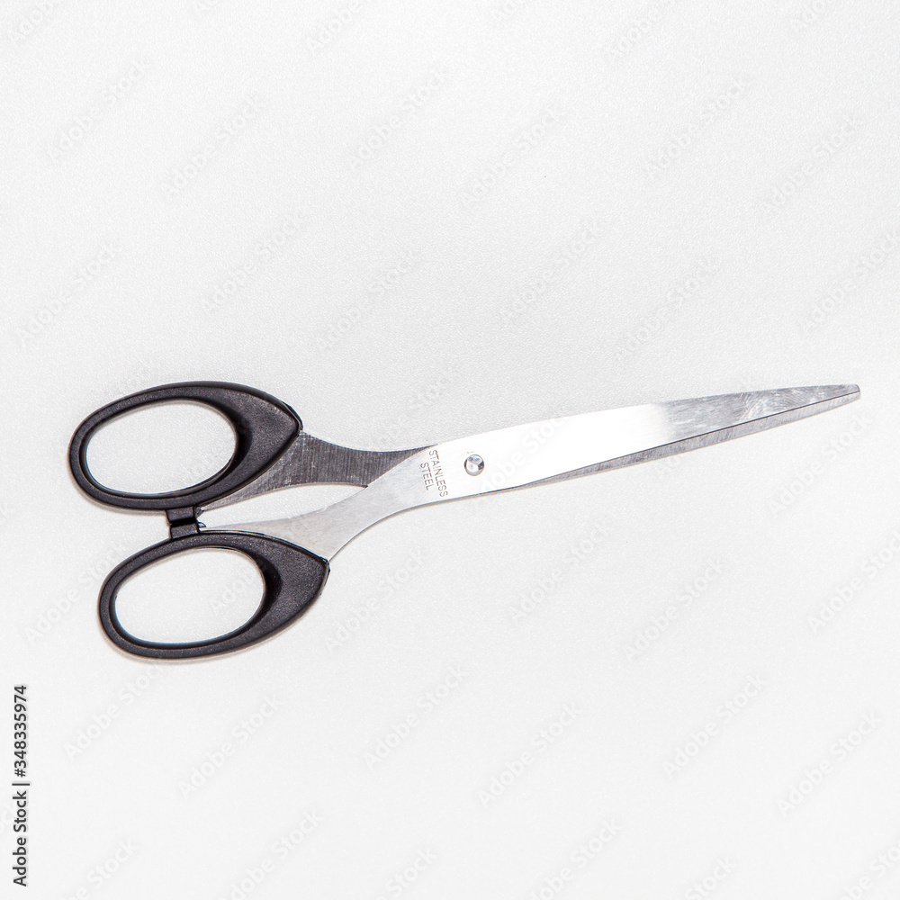 Scissors isolated on bright white background with silver color, top view Scissors isolated on bright white background with silver color, top view