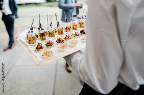 photo of a waiter holding snacks at a wedding