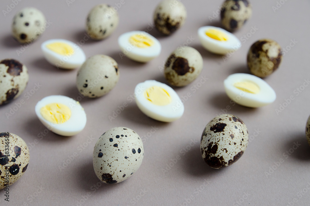 Pattern of boiled quail eggs on beige background, front view