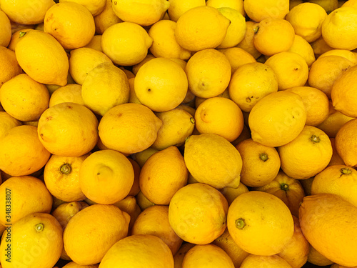 lots of ripe citrus yellow lemons to eat like a background