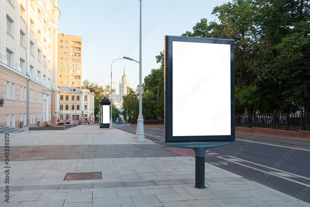 Billboard vertical on the sidewalk next to the road. Mock-up. Billboard vertical on the sidewalk next to the road. Mock-up.