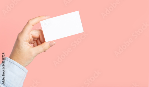 Female hands with cutaway, blank menu, discount card, business card on color pink beauty background. Template for design. Branding mockup template Mockup