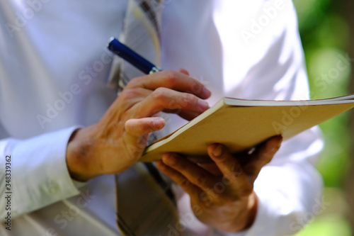 businessman writing on a notebook and successful planning