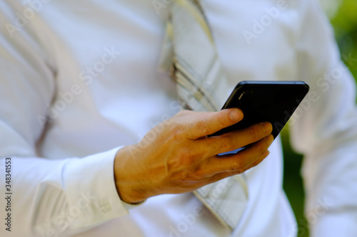 close up businessman using a smartphone and space for text
