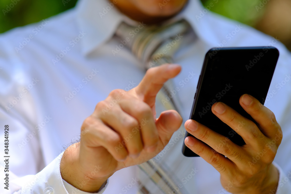 close up businessman using a smartphone and space for text close up businessman using a smartphone and space for text