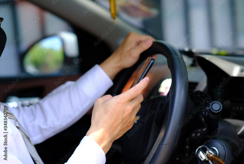 businessman using his phone while traveling drive in a car