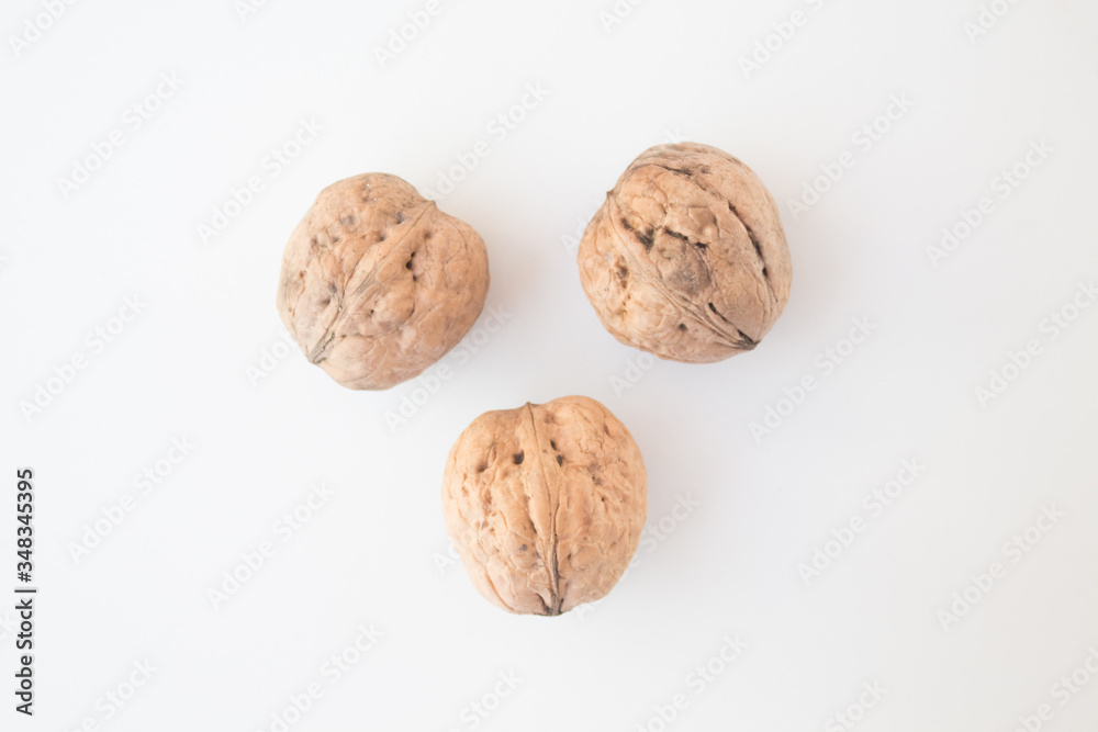 Walnuts on a white background close-up. The concept of vegan and vegetarian. Getting Vitamins from Nuts Walnuts on a white background close-up. The concept of vegan and vegetarian. Getting Vitamins from Nuts