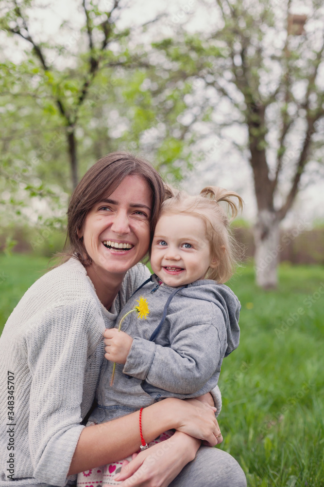 Beautiful mother with little daughter in spring Beautiful mother with little daughter in spring