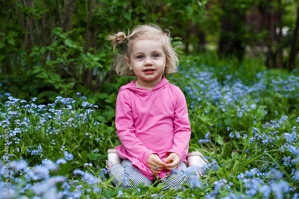 Portrait of beautiful child in forget me not flowers Portrait of beautiful child in forget me not flowers
