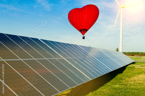 hot air balloon red heart over solar panel - ecological energy dream