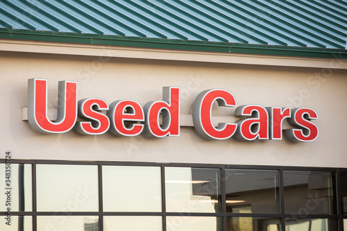 sign on a building indicating used cars