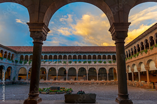Exterior patio of the Qorikancha Sun Temple and Santo Domingo convent with Inca walls and stonework at sunset, Cusco, Peru. photo