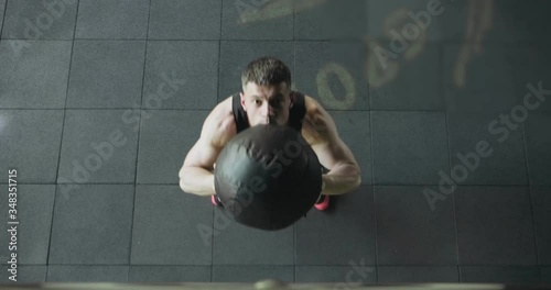 Young men doing intense training slams with a medicine ball. Top view