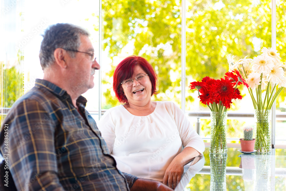 Fototapeta premium Mature couple in quarantine spends time at home on fathers day. chat pleasant time concept.