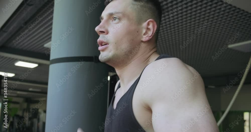Man running on treadmill in gym. Men doing difficult cardio workout with air runner