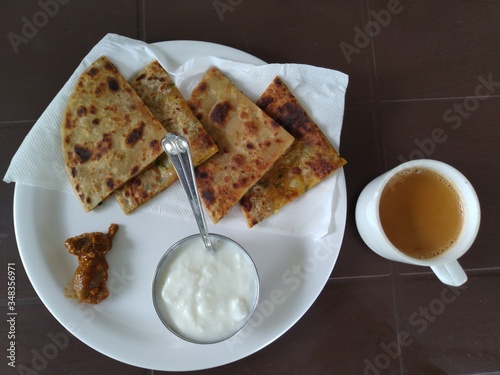 Tasty potato Parathas with curd and tea, Indian Breakfast
 photo