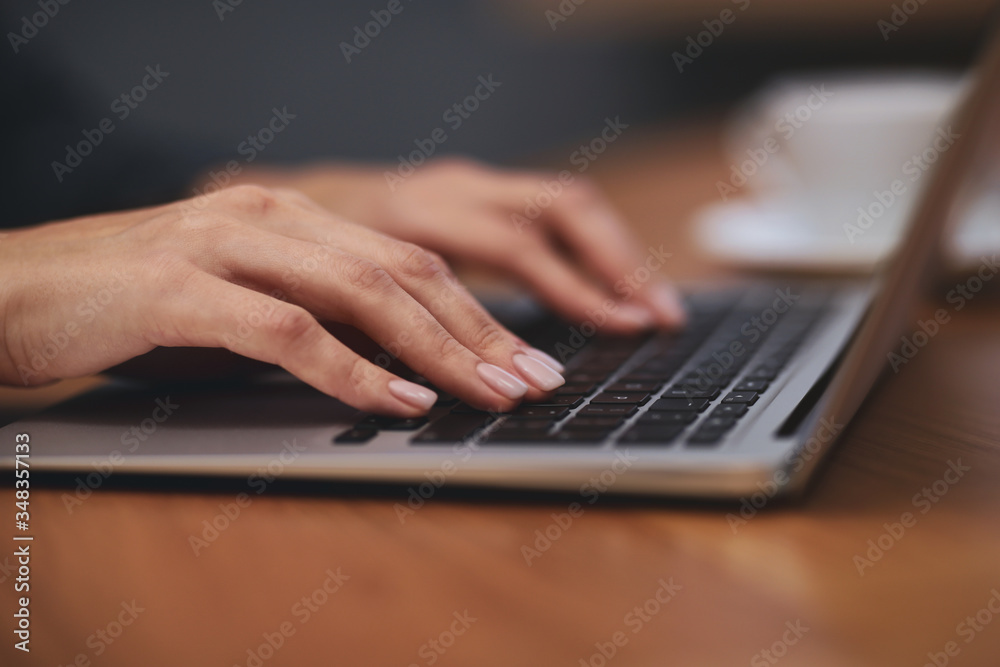 Woman working on modern laptop at table, closeup Woman working on modern laptop at table, closeup