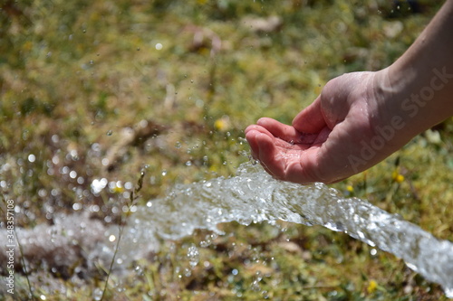 water flowing in the hands © Manos