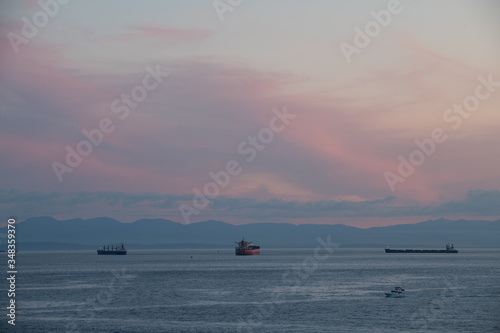 Tanker and Freighter Ships Wait in Burrard Inlet Vancouver, British Columbia to load and unload at the Port of Vancouver
