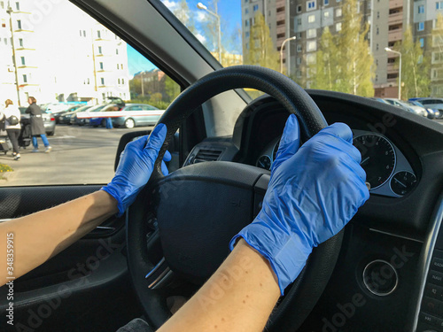 hands in the car with medical  gloves driving car person