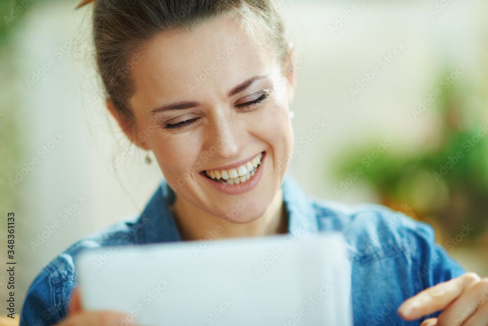 Fototapeta premium female with tablet PC study online in modern house in sunny day