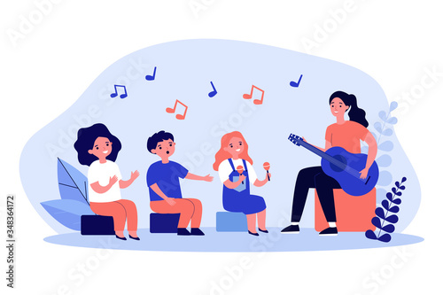Young woman playing guitar for children flat vector illustration. Cartoon kids singing, clapping and playing musical instruments. Music education and daycare concept