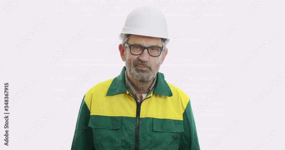 Portrait of old man in suit and helmet Isolated over white background, Human emotions and facial expressions. Portrait of old man in suit and helmet Isolated over white background, Human emotions and facial expressions.