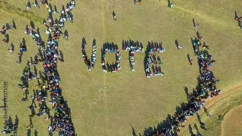 Top view of people forming letters of the word  vote