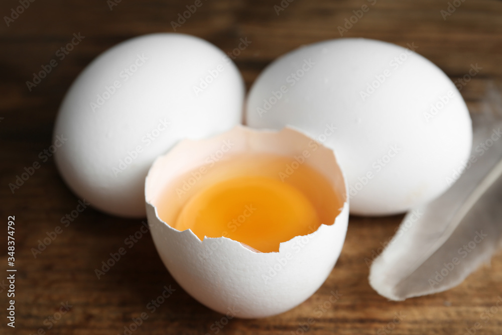 Fresh raw chicken eggs on wooden table, closeup Fresh raw chicken eggs on wooden table, closeup