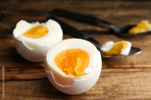 Tasty boiled chicken eggs on wooden table, closeup