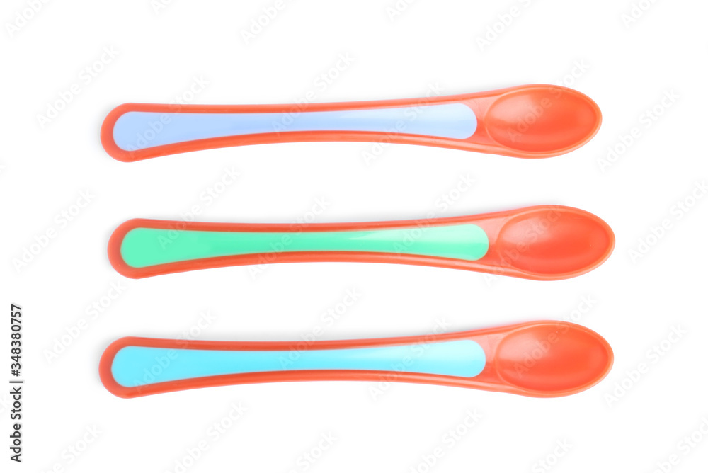 Colorful plastic spoons isolated on white, top view. Serving baby food Colorful plastic spoons isolated on white, top view. Serving baby food
