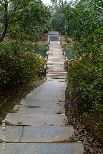 Wooden bridge over little river in city park