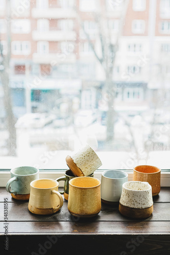Ceramic mugs on windowsill