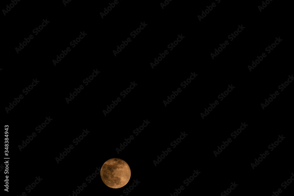 Full white Moon with some clouds passing by in the dark sky Full white Moon with some clouds passing by in the dark sky