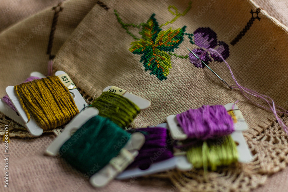 Cross-stitch art of purple grapes made with various colors on cloth Cross-stitch art of purple grapes made with various colors on cloth