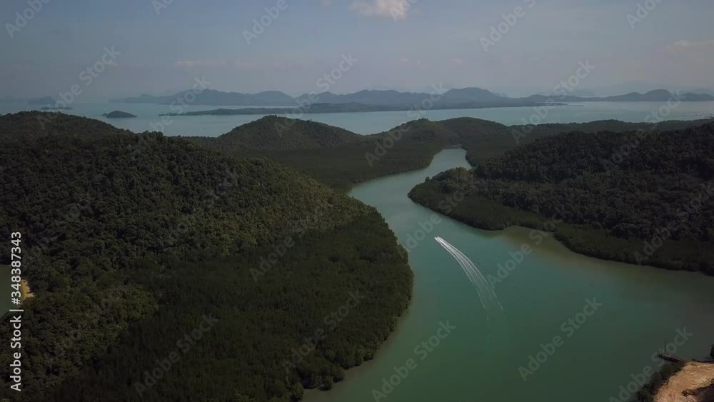 Aerial shot of a gulf and islands with a jetski leaving a trace on the water Aerial shot of a gulf and islands with a jetski leaving a trace on the water