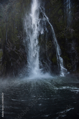 waterfall in milford sound new zealand