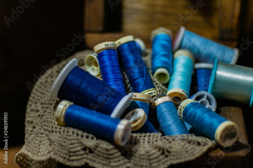 Wooden box with blue threads on a cloth