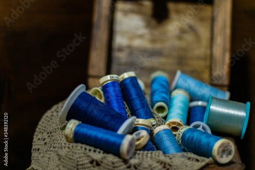 Wooden box with blue threads on a cloth
