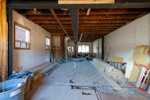 Open concept renovation at residential house in Toronto, Ontario. On the floor are visible tools and wood supply. photo