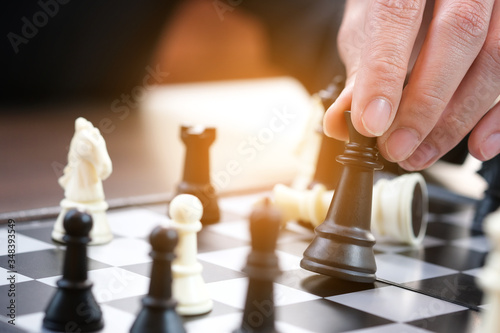 The hands of the people on the competition and the strategic planning guidelines on the checkmate board. Succeed