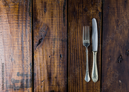 Cutlery set on a rustic wooden table. Fork and knife. Food concept. Copy Space