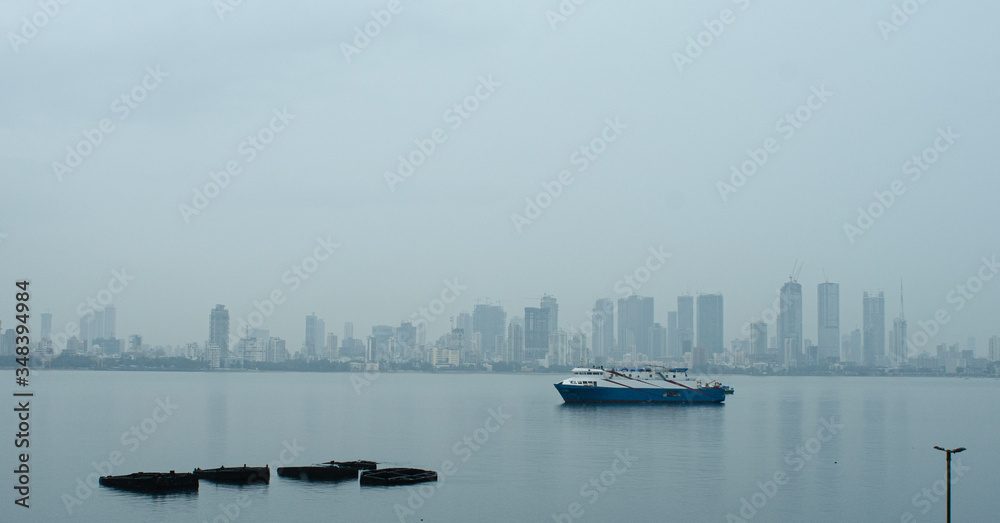Bombay skyline with ferry in the foreground.