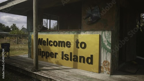 dolly in revealing the cabin with a sign saying welcome to slipper island.mov photo