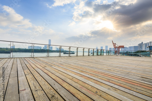 Empty plank square and city skyline with buildings in shanghai at sunset,China.