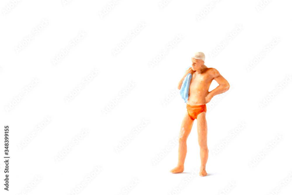 Miniature people wearing swimsuit standing on white background , Summer time concept Miniature people wearing swimsuit standing on white background , Summer time concept